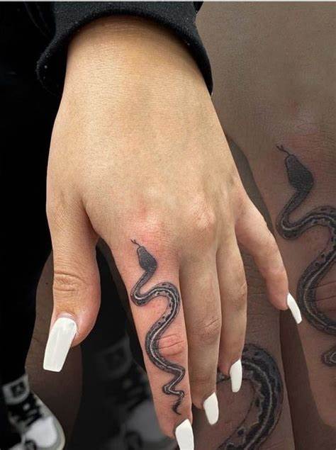 Finger Tattoo Designs You Can Consider For Getting Inked - Top 26 2 1. Woman with Snake Tattoo on Her Finger