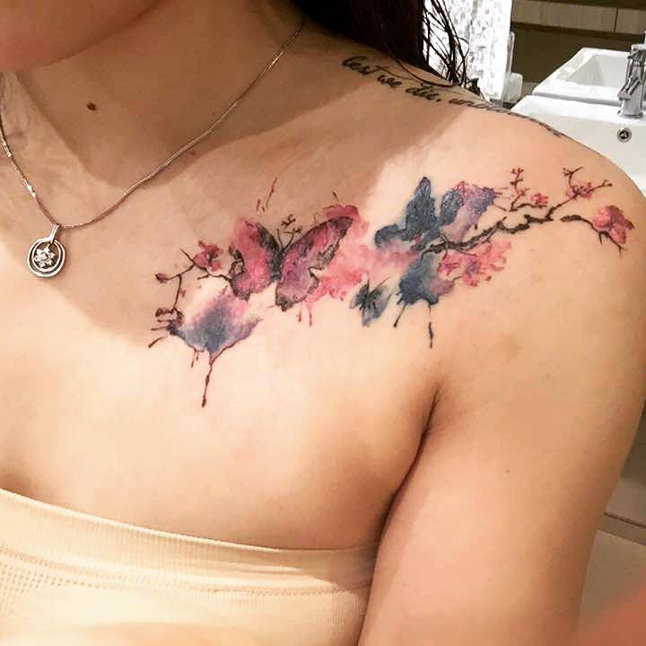 Top Cherry Blossom Tattoos Ideas -30+ Options to Choose From 3 3. Tattoo of a Realistic Watercolor Cherry Blossom on a Woman's Triceps