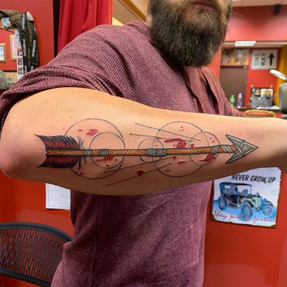 Colorful tribal arrow tattoo