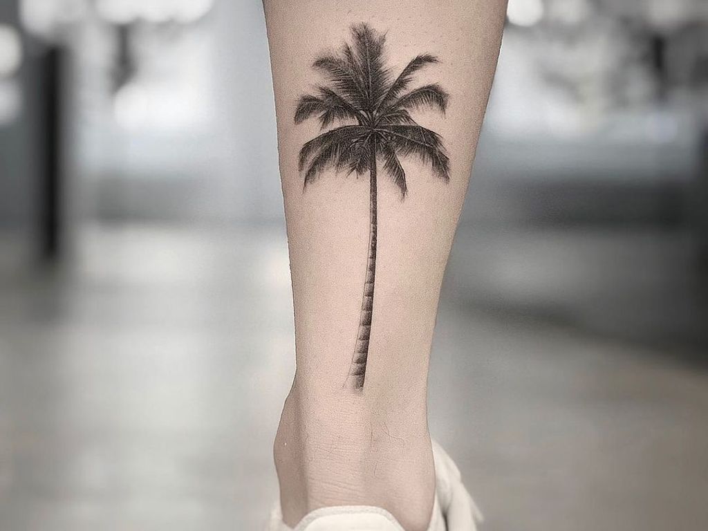 13. TATTOO OF AN ANKLE PALM TREE