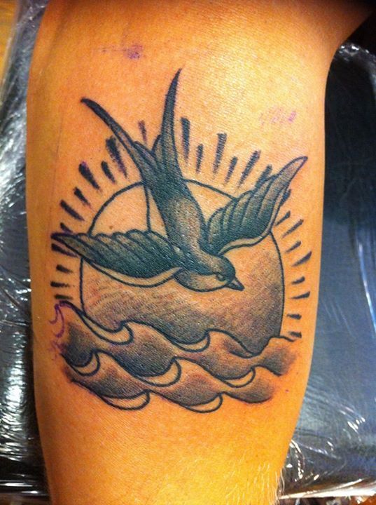 Sparrow and sun chest tattoo