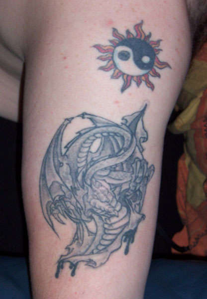 Tattoo of a dragon and the sun