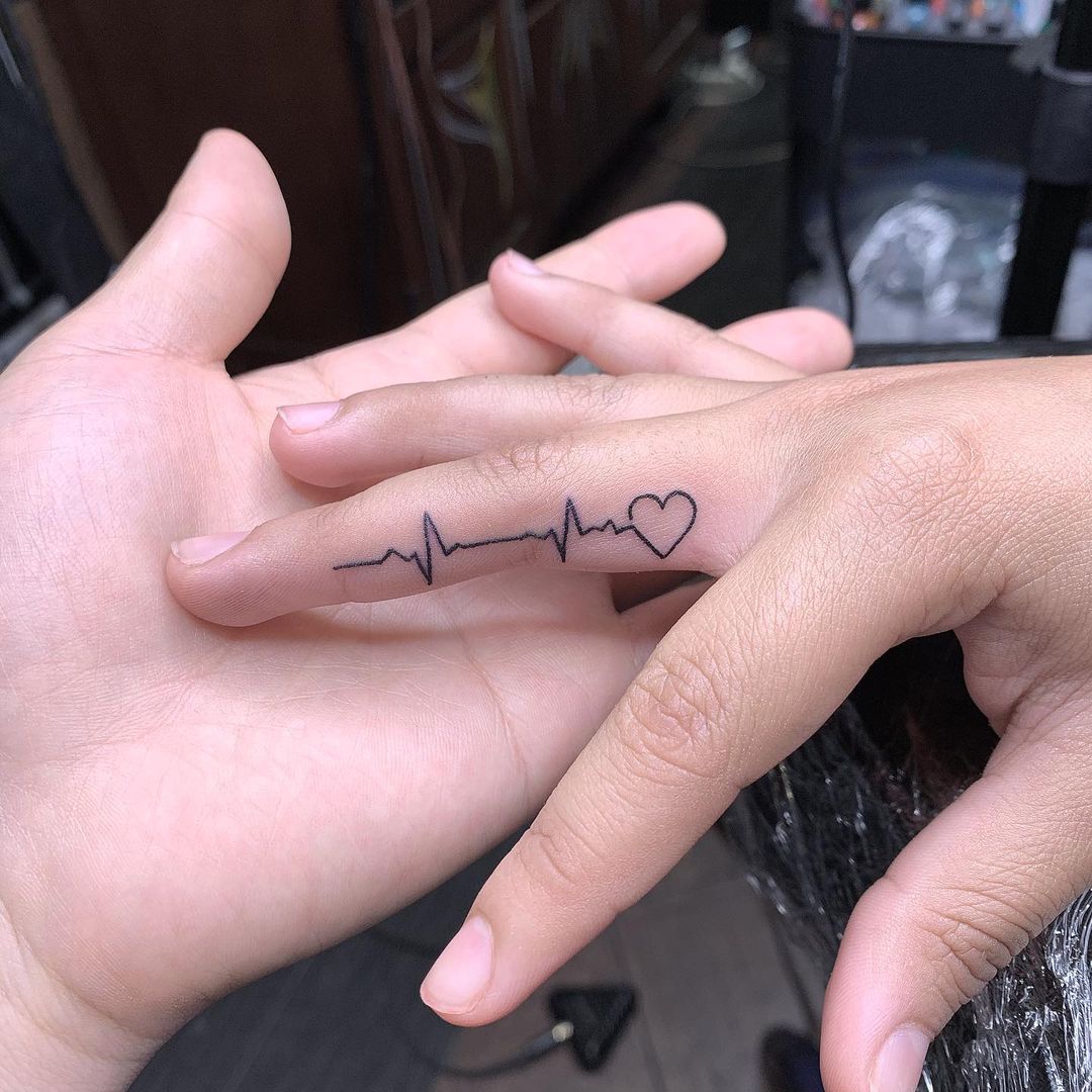 Finger Tattoo of a Small Heartbeat