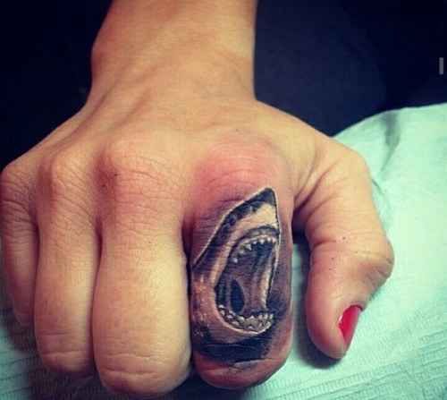 Shark Tattoo Ideas - Symbolizing Authority and Guardianship 14 14. Small Finger Shark Tattoo Design