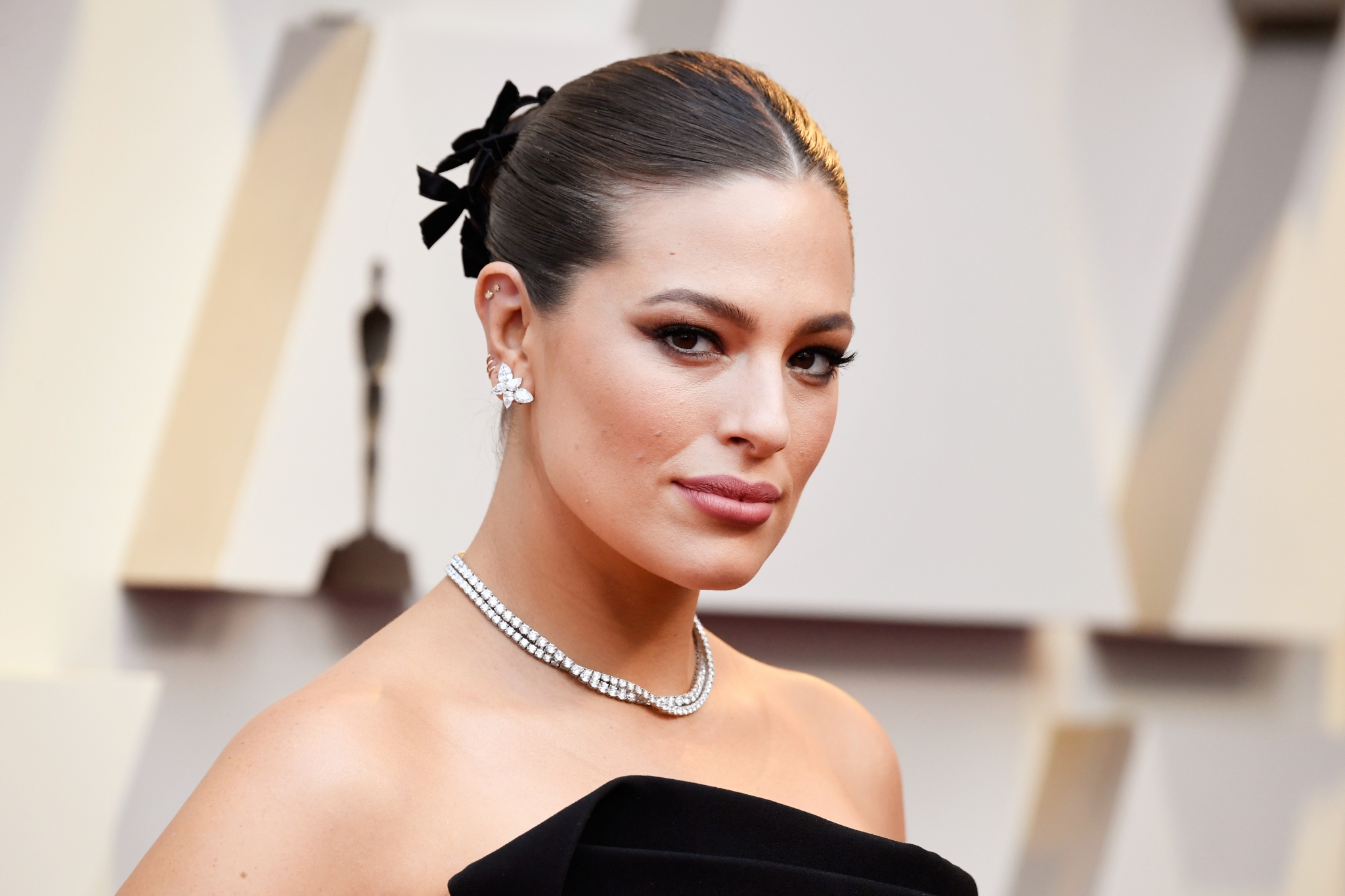 Mid-parted Sleek Bun with an Accessory at the Back