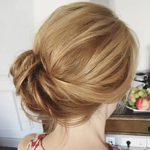Twisted low bun with side part